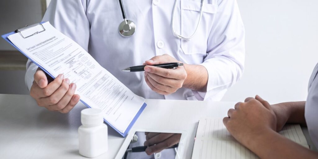 Doctor holding a clipboard and explaining a medical document to a patient.