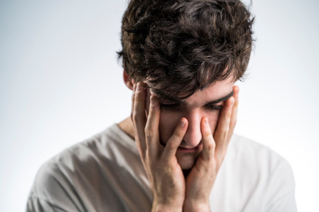 A person with hands on their head, depicting stress and anxiety.